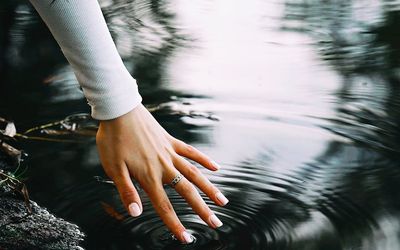 Gentle ripples on a calm water surface with cyan reflections.